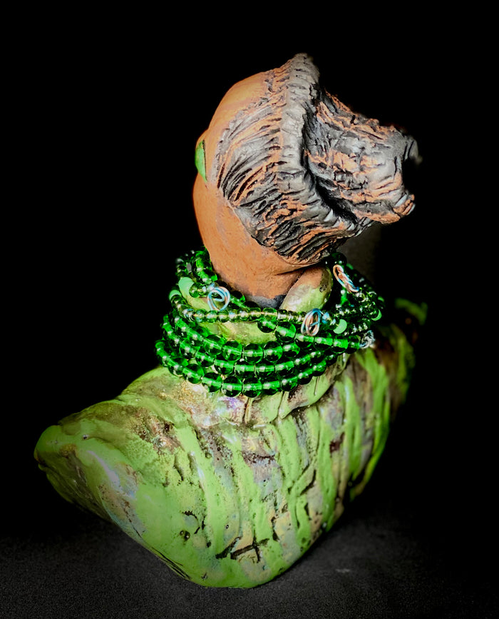 Delia looks up with joy and anticipation! Delia stands 7"x 6" x 3" and weighs 1.50 lbs. She wears an awesome metallic green textured copper robe. Delia has braided clay hair up in a bun. She has a honey brown complexion. Delia could make an excellent gift for your BFF! Delia will make for great conversation in your home. Free Shipping! Check out our Shipping and Return policy