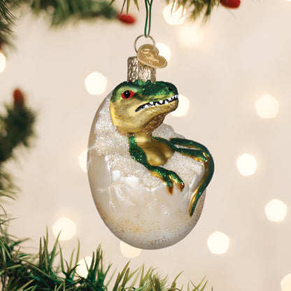 Baby dinosaur hatching from an egg glass Christmas ornament