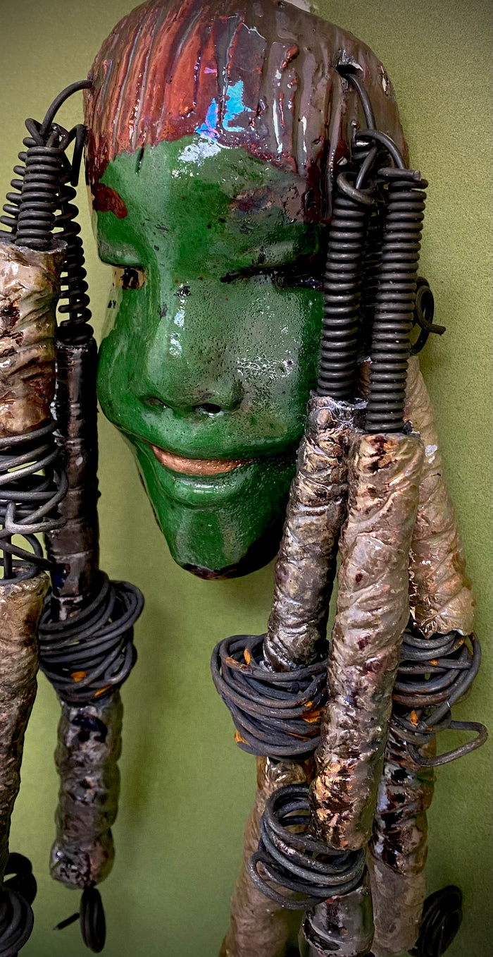 I started making art soon after seeing authentic African artwork at the Smithsonian Museum of African Art. I was in total awe. Bryce was inspired by my visit there.  Bryce is 4”x 10” and weighs 1  lbs. She has an  awesome emerald green complexion. Bryce wears a textured copper headdress with textured metallic white spiral coiled beads of hair. Bryce is ready to be installed in your home!