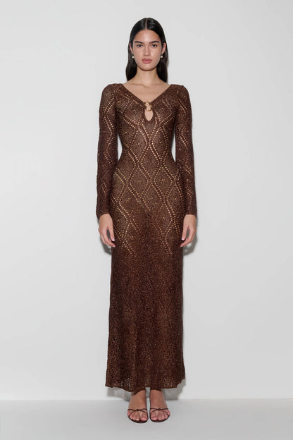 Woman wearing a brown lurex crochet maxi dress.