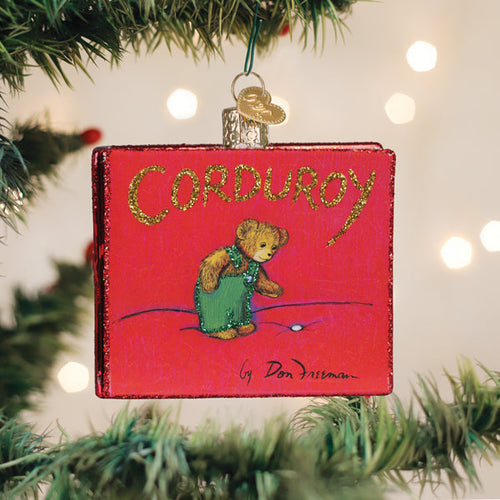 Corduroy book cover glass Christmas ornament hanging on a tree