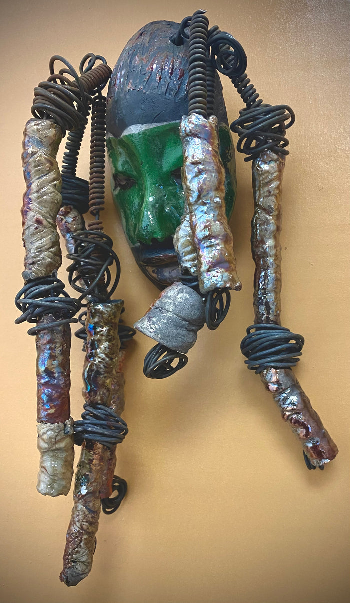 Meet Craig! I am going to make more with colors in the face like Craig. I like how the green and copper complements each other.  I started making art soon after seeing authentic African artwork at the Smithsonian Museum of African Art. I was in total awe. Craig was inspired by my visit there.  Craig is   4"x 10" and weighs 12 ozs. He has a two tone  green and copper face. Craig has hand coiled 16 gauge wire  hair with over  10 metallic raku beads.