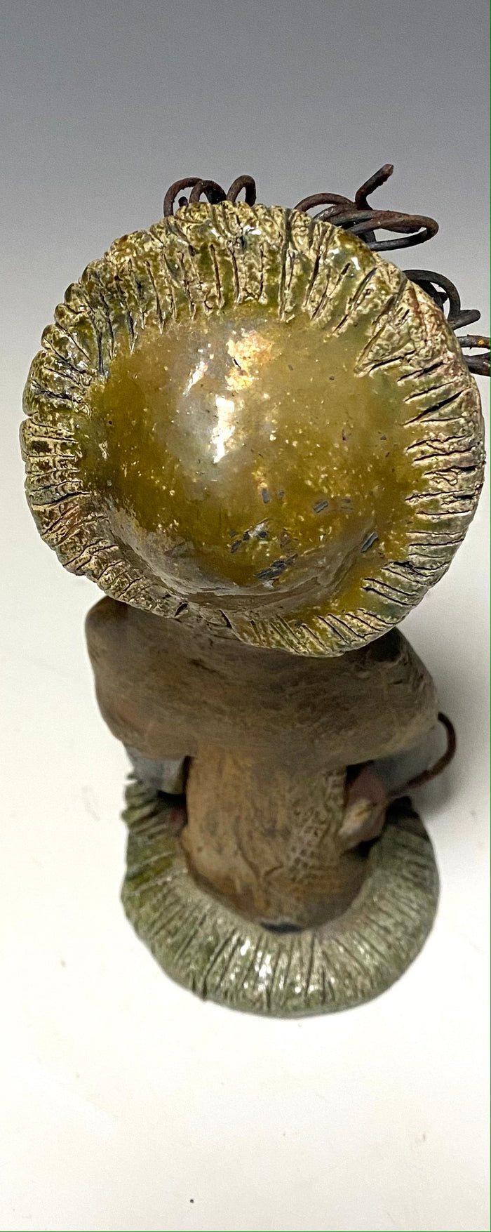 Meet Edna! Edna stands 6" x 3.5”x 4" and weighs  12.4 ozs.  She has a dark lovely smokey black complexion. Edna has a glossy green and copper metallic dress.  She clinches her designer  Dark red purse. Edna wears a designer hat as well. With the current situation we All are going through,  Edna will place a smile on your face during this challenging time.  If not return Edna within 30 days after receiving her for a complete refund.