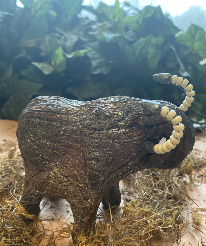 Have you HERD!!!!!!     Elephants are one of my favorite animals to create. They are so majestic"  Just one of these lovely Raku Fired Elephant will make an excellent gift for your  BFF,  or just for you .    This raku fired elephant sits 4.5" x 3" x 4" and weighs 1 lbs. She has beaded tusks and a textured copper charcoal body. This one will be nice to add your Herdew Collection!