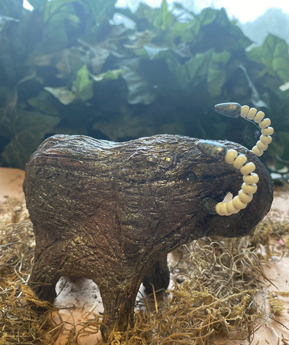Have you HERD!!!!!!     Elephants are one of my favorite animals to create. They are so majestic"  Just one of these lovely Raku Fired Elephant will make an excellent gift for your  BFF,  or just for you .    This raku fired elephant sits 4.5" x 3" x 4" and weighs 1 lbs. She has beaded tusks and a textured copper charcoal body. This one will be nice to add your Herdew Collection!