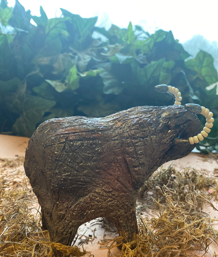 Have you HERD!!!!!!     Elephants are one of my favorite animals to create. They are so majestic"  Just one of these lovely Raku Fired Elephant will make an excellent gift for your  BFF,  or just for you .    This raku fired elephant sits 4.5" x 3" x 4" and weighs 1 lbs. She has beaded tusks and a textured copper charcoal body. This one will be nice to add your Herdew Collection!