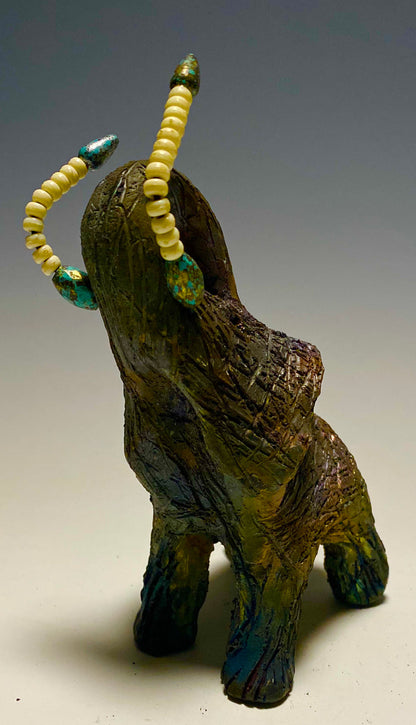 Have you HERD!!!!!!     Elephants are one of my favorite animals to create. They are so majestic"  Just one of these lovely Raku Fired Elephant will make an excellent gift for your  BFF,  or just for you .    This raku fired elephant stands 6" x 4" x 5" and weighs 1 lb. She has beaded tusks and a textured charcoal  and copper metallic body. This one is nice to add your Herdew Collection!