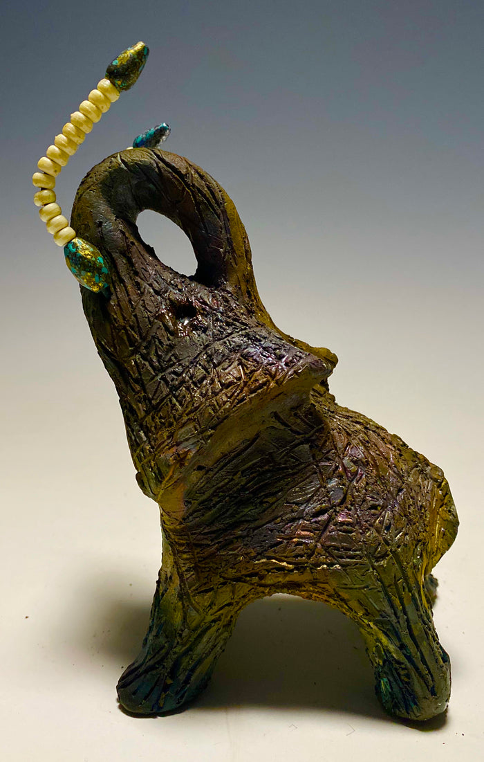 Have you HERD!!!!!!     Elephants are one of my favorite animals to create. They are so majestic"  Just one of these lovely Raku Fired Elephant will make an excellent gift for your  BFF,  or just for you .    This raku fired elephant stands 6" x 4" x 5" and weighs 1 lb. She has beaded tusks and a textured charcoal  and copper metallic body. This one is nice to add your Herdew Collection!