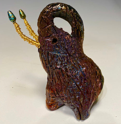 Raku Elephant Have you HERD!!!!!!  Just one of these lovely Raku Fired Elephant will make an excellent gift for your  friend, sorority or for your home’ special place centerpiece.  7" x 4" x 3" 11 ozs. Beautiful metallic gold and orange raku elephant For decorative purposely only.