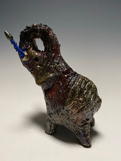 Raku Elephant Have you HERD!!!!!!  Just one of these lovely Raku Fired Elephant will make an excellent gift for your  friend, sorority or for your home’ special place centerpiece.   6" x 4" x 4" 1 lbs Beaded tusk with blue and gold wire Beautiful  colorful metallic raku elephant For decorative purposely only