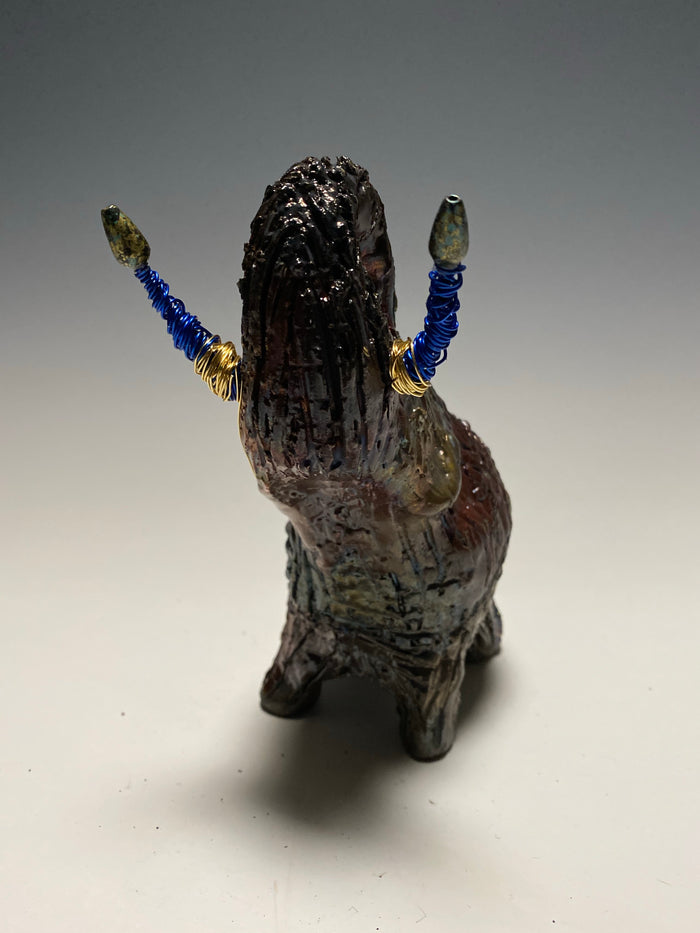 Raku Elephant Have you HERD!!!!!!  Just one of these lovely Raku Fired Elephant will make an excellent gift for your  friend, sorority or for your home’ special place centerpiece.   6" x 4" x 4" 1 lbs Beaded tusk with blue and gold wire Beautiful  colorful metallic raku elephant For decorative purposely only