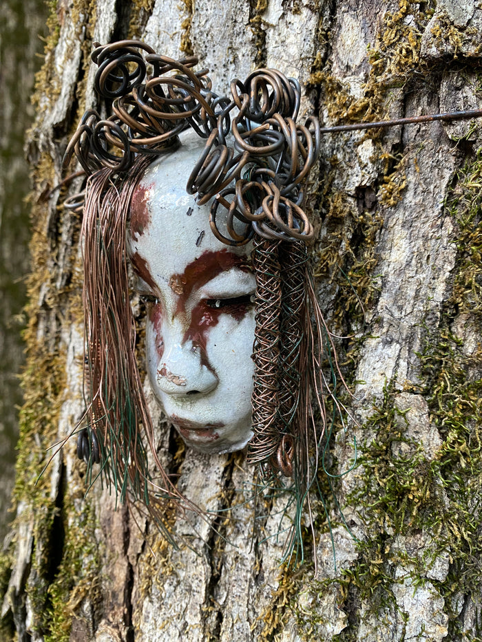 Equip your walls with the unique artwork of Weni. She is approximately 4”x5”.  Featuring over 10 ft of hair adorned, this folk art piece is sure to draw attention with its  antique white and copper crackle face and lips. Invigorate any area with a one-of-a-kind piece; perfect for starting conversations or simply for eye-catching decor! Have queries? Just ask!