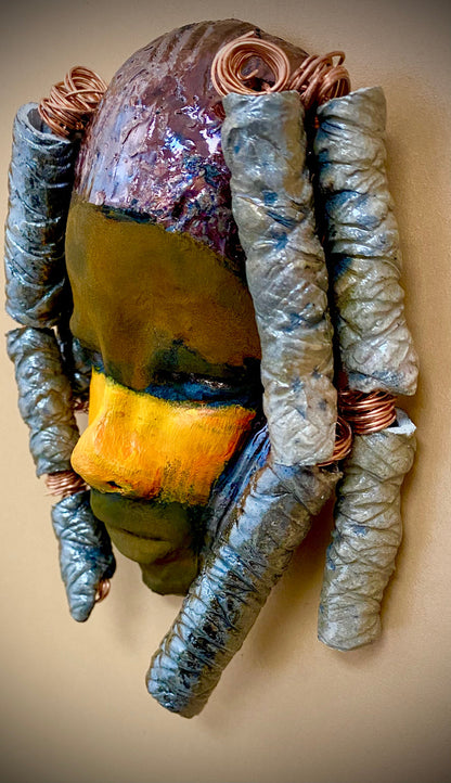 I started making art soon after seeing authentic African artwork at the Smithsonian Museum of African Art. I was in total awe.   Lavender was inspired by my visit there.  Lavender  is 4”x 7” and weighs 10  ozs. She has a two tone copper earthy complexion. Lavender has four spiral off white coils of  beaded hair. She is ready to be installed in your home! I suggest a small space with a warm background.