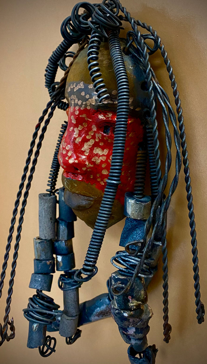 Meet Mackenzie! I started making art soon after seeing authentic African artwork at the Smithsonian Museum of African Art. I was in total awe.  Mackenzie was inspired by my visit there.  Mackenzie is 5”x 11” and weighs 1 lbs. She has a two tone copper matte and red complexion. Mackenzie has spiral coils and handmade beads for hair. She is ready to be installed in your home!