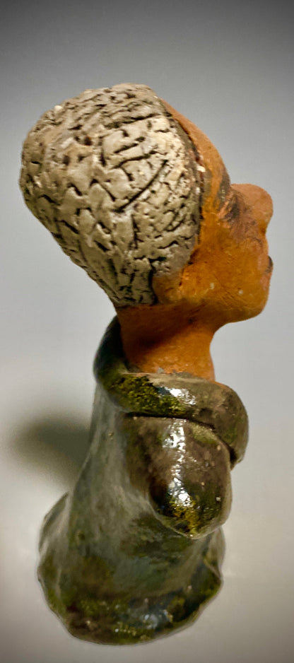 Mr. Charles has a story to tell!  Do you See the wisdom in his face? Mr. Charles  stands 5"x 3" x 2.5" and weighs 11 ozs. He wears a copper green metallic jacket. Mr. Charles's complexion is honey brown and he has salt and pepper hair.