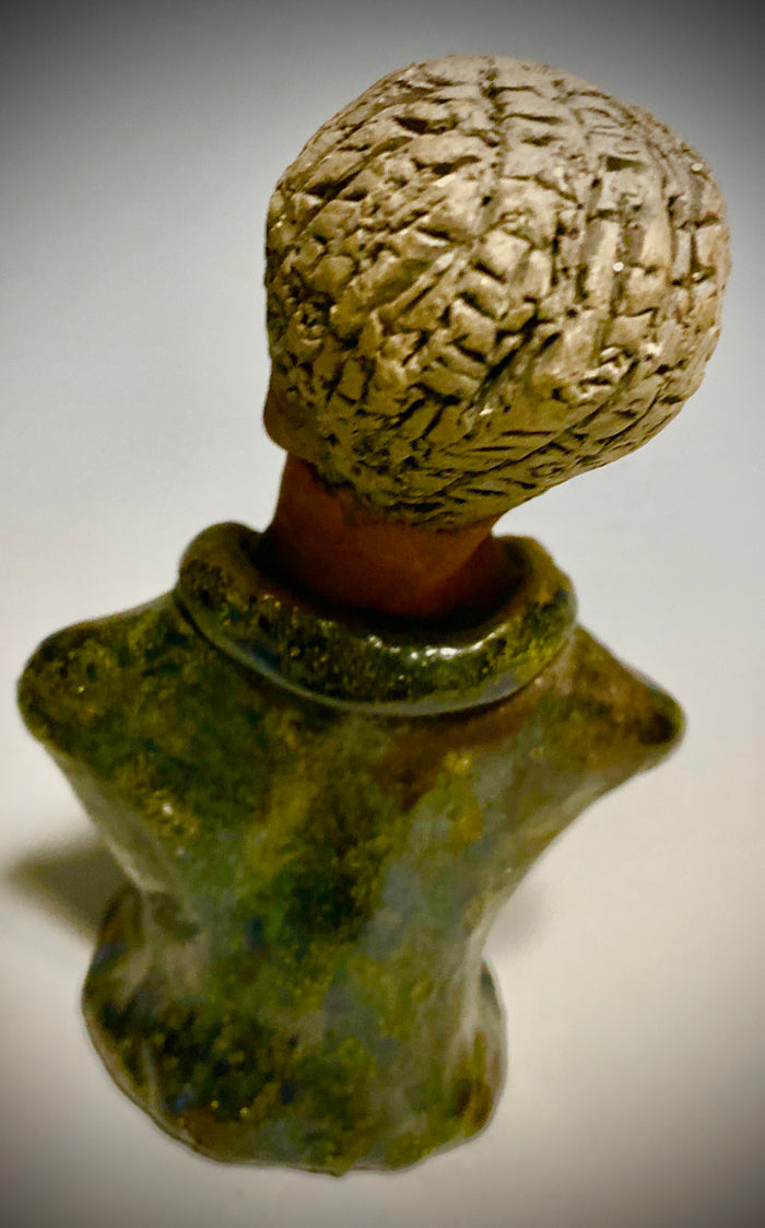 Mr. Charles has a story to tell!  Do you See the wisdom in his face? Mr. Charles  stands 5"x 3" x 2.5" and weighs 11 ozs. He wears a copper green metallic jacket. Mr. Charles's complexion is honey brown and he has salt and pepper hair.