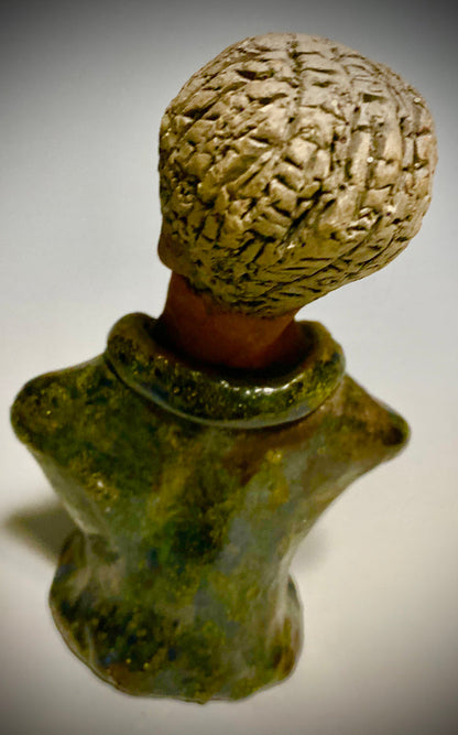 Mr. Charles has a story to tell!  Do you See the wisdom in his face? Mr. Charles  stands 5"x 3" x 2.5" and weighs 11 ozs. He wears a copper green metallic jacket. Mr. Charles's complexion is honey brown and he has salt and pepper hair.