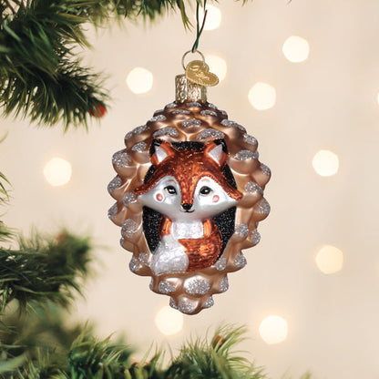 Piney fox glass ornament of a fox peeking from a pine cone