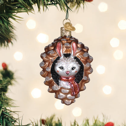 Piney rabbit glass ornament of a bunny nestled in a pine cone