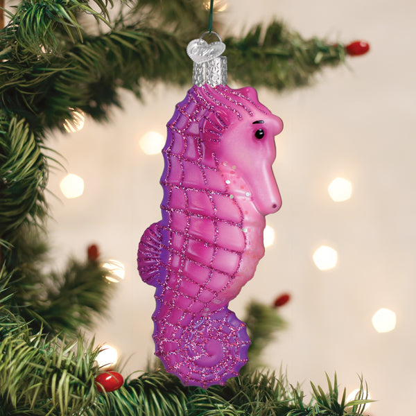 Shimmering pink seahorse glass ornament with glitter accents