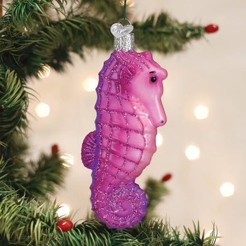 Shimmering pink seahorse glass ornament with glitter accents