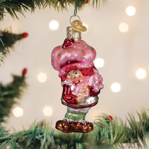 Strawberry Shortcake and Custard glass ornament hanging on a Christmas tree