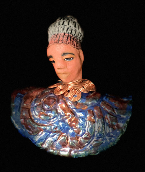 Meet Tia! Tia looks up with joy and anticipation! Tia stands 7" x 6" x 4" and weighs 1.90 lbs. She has a beautiful textured copper and blue robe. Tia has braided clay hair up in a bun. She has a honey brown complexion and soft light brown lips. Tia will make for great conversation in your home.  Free Shipping! Check out our Shipping and Return policy
